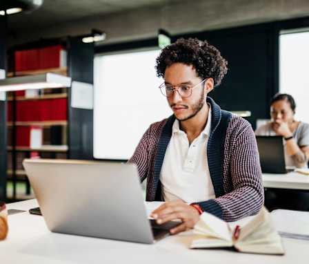 Person on laptop in library